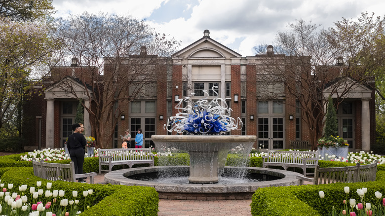 Fountain at the Atlanta Botanical Garden surrounded by hedges and tulips