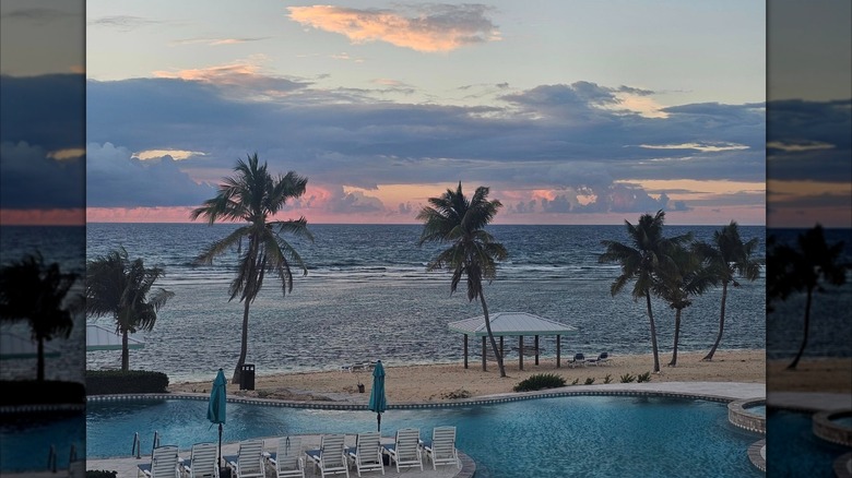 View of an empty pool at sunset at the Cayman Brac Beach Resort
