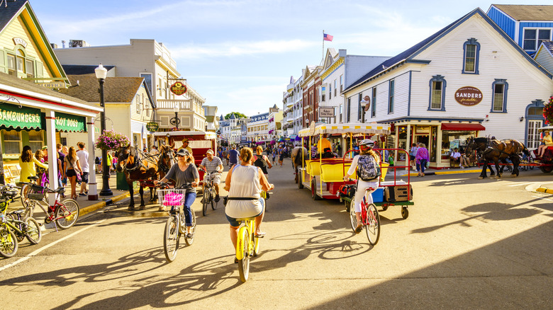 Vacationers cycling and walking on Market Street on Mackinac Island