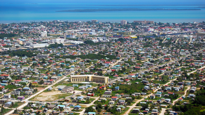 Aerial view of Belize City with ocean in the background.