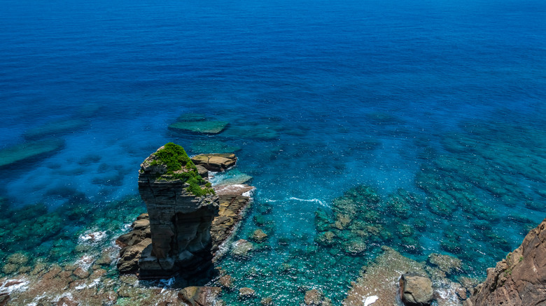 Aerial view of rock formations under clear ocean off the coast of Yonaguni, Okinawa, Japan