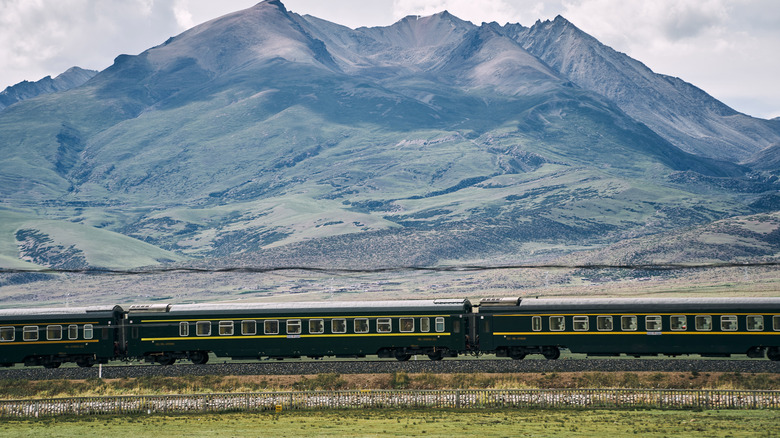 Green train from a distance on the Tibetan plateau, China