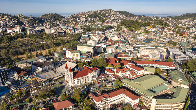 An aerial view of Bagiuo, Burnham Park, and mountains on Luzon