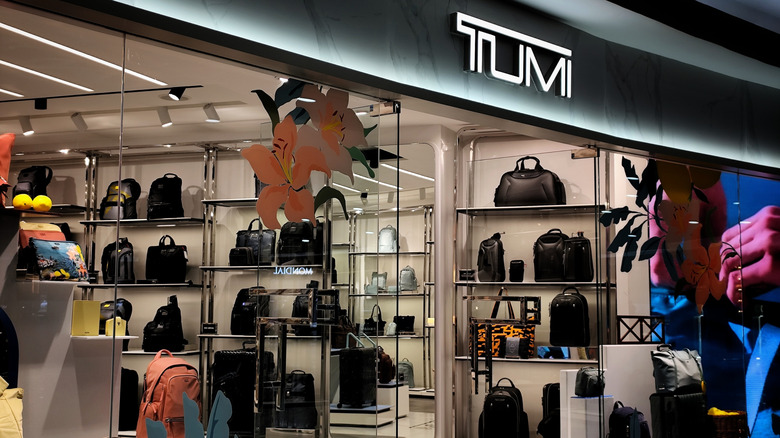 A Tumi store exterior inside a shopping area