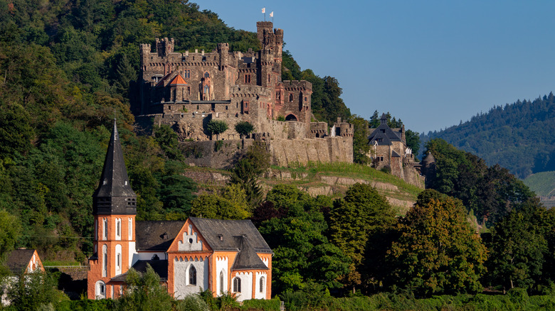 Rheinstein Castle with a church in the foreground
