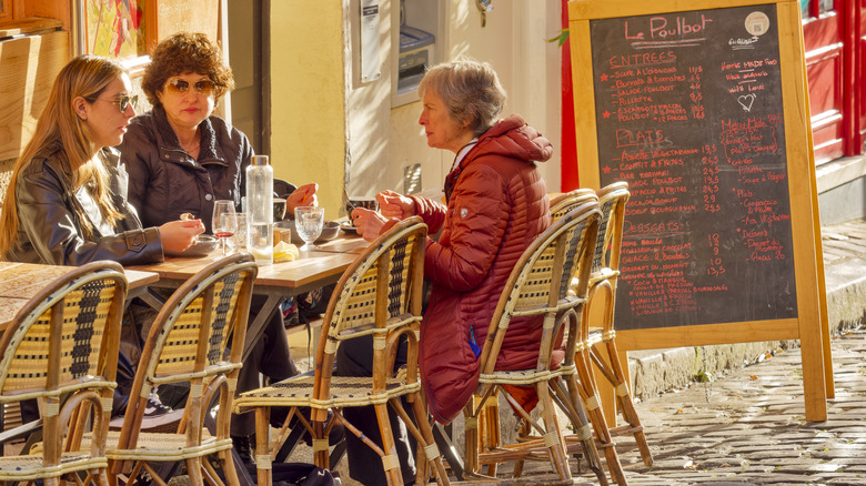 People dining at a small café in Paris, France