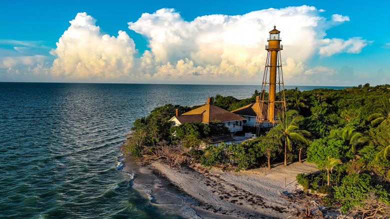 Aerial view of Sanibel Lighthouse rising behind tranquil waters
