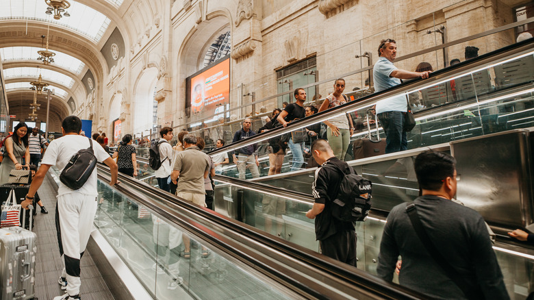 The interior of a crowded train station in Milan