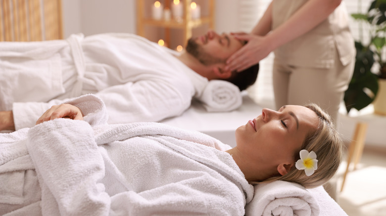 Couple receiving a relaxing massage in a spa salon.