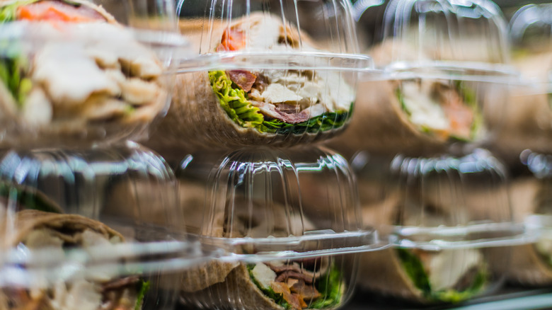 Pre-packaged sandwiches displayed in a commercial refrigerator
