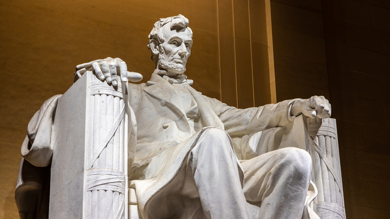 White marble Abraham Lincoln statue sitting in a chair at the Lincoln Memorial, Washington, D.C.
