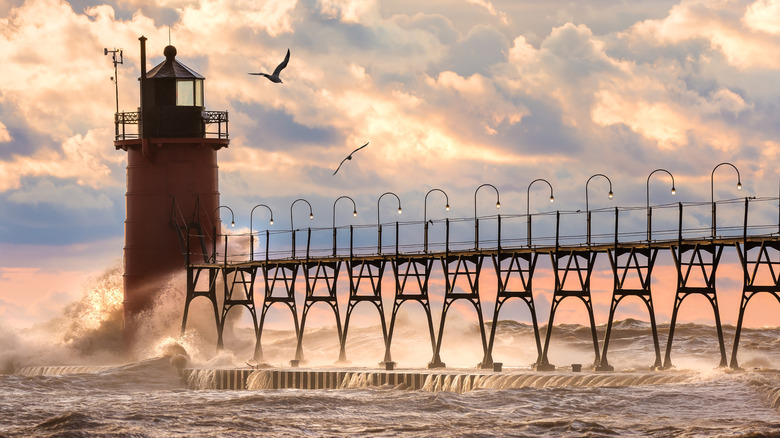 Crashing waves hit a lighthouse along the shores of Lake Michigan on a stormy day