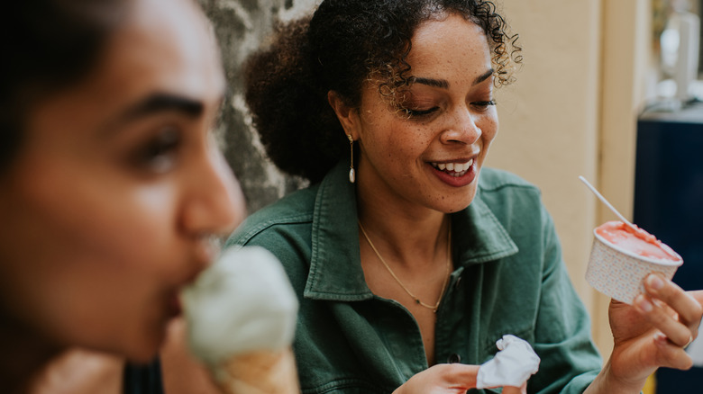 Woman holding gelato and a napkin