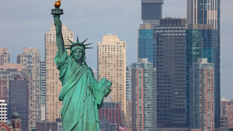 An aerial view of the Statue of Liberty with Manhattan in the background