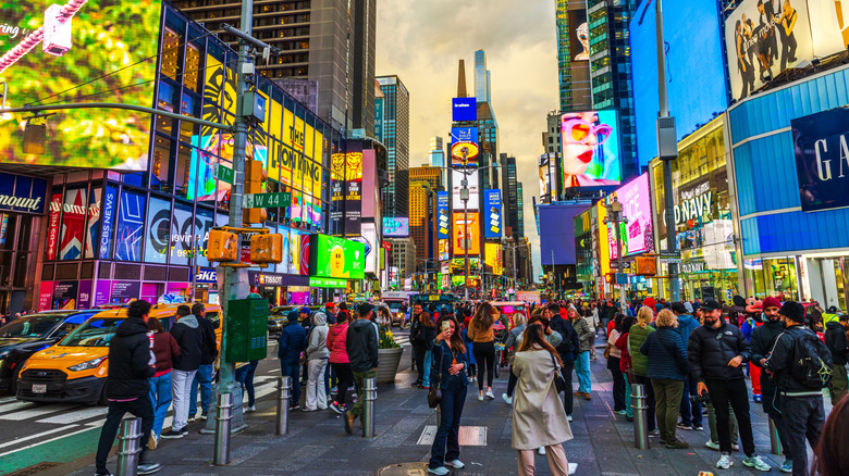 Numerous people and billboards in Times Square