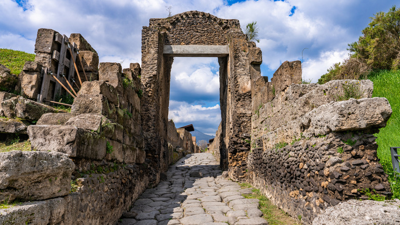 Doorway and ancient road in the ruined city of Pompeii, Italy
