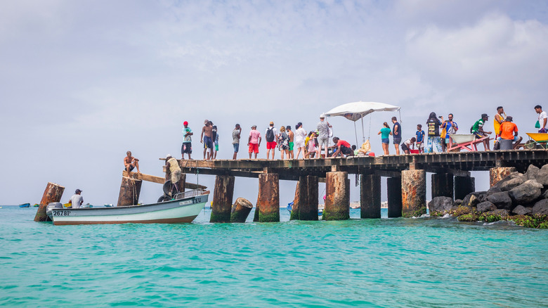 Fishermen and tourists on the O Pontão pier in Santa Maria