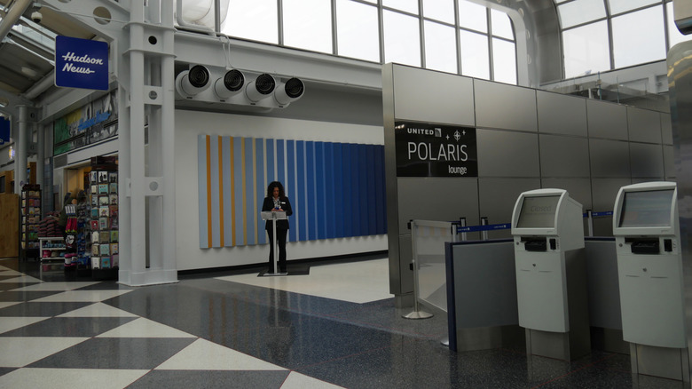 An airline crew member stands at the entrance to the Polaris Lounge of the United Airlines inside the Terminal 1 of O'Hare International Airport.