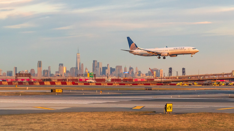 Airplane landing at Newark Liberty Airport at golden hour