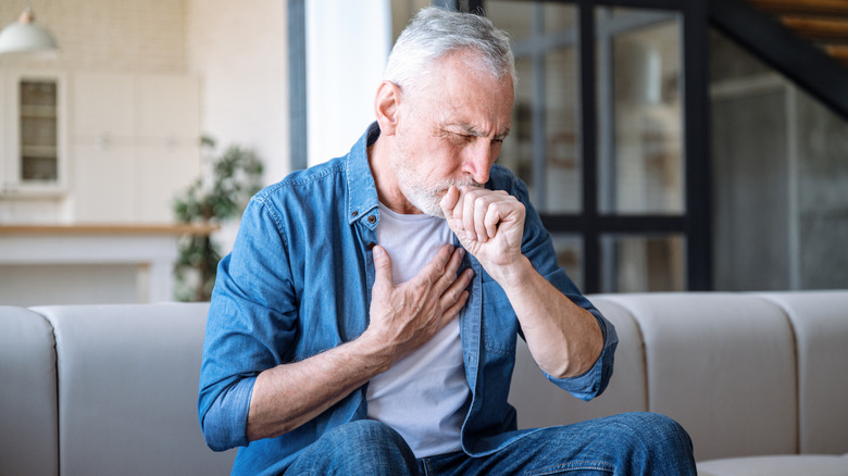 A man coughing and having difficulty breathing