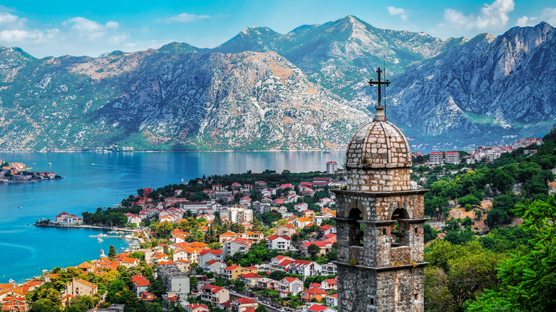 Bell tower of Kotor with the deep blue bay and mountains in the background, Montenegro