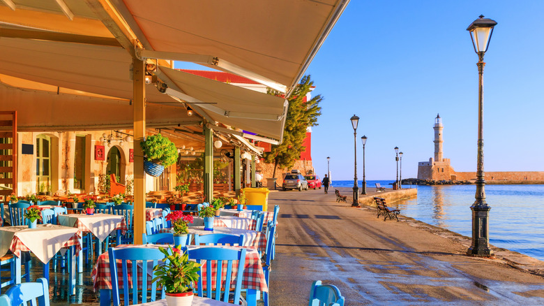 Patios line the seaside promenade in Crete's old town Chania, Greece