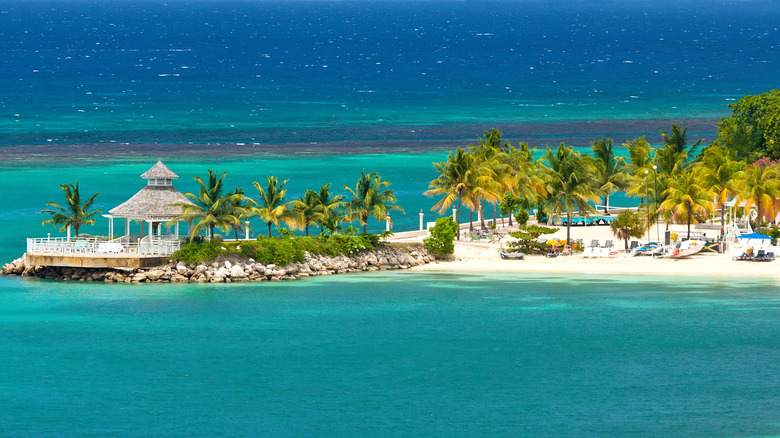 View of private beach and gazebo surrounded by water at Sandals resort in Ocho Rios, Jamaica.