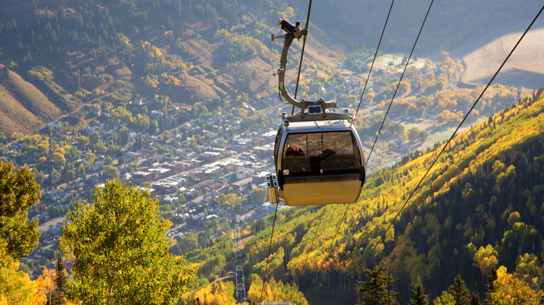 A gondola at Telluride Mountain in Colorado surrounded by fall foliage