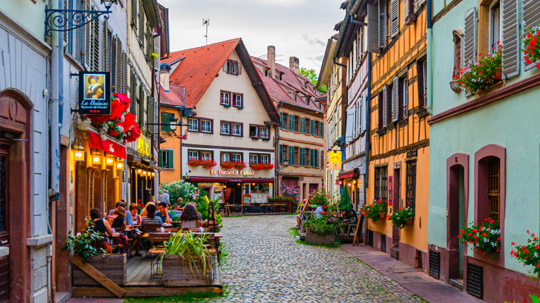 Old town Strasbourg city historic centre La Petite France, pedestrian street with medieval houses, and colorful buildings.
