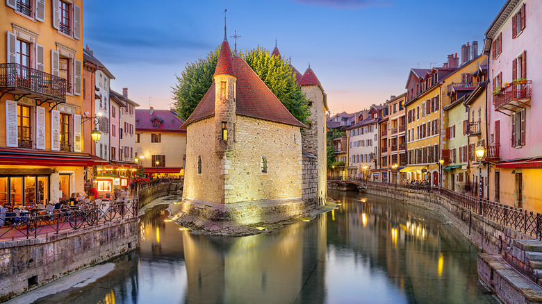 The iconic Palais de l'île rises in the middle of a river in Annecy, France