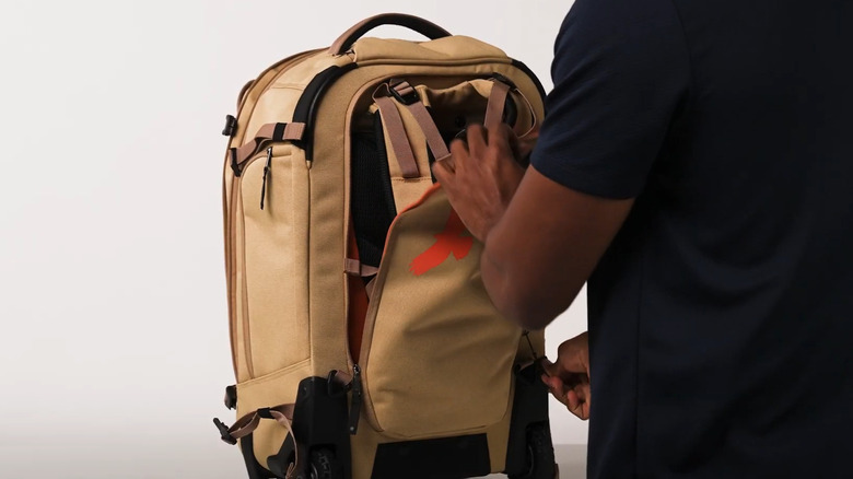 Shot of Eagle Creek's Gear Warrior XE being converted from a rolling bag to a backpack