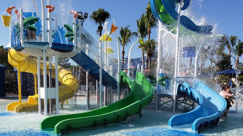 Colorful water slides at a children's play area in The Grove Resort & Water Park Orlando