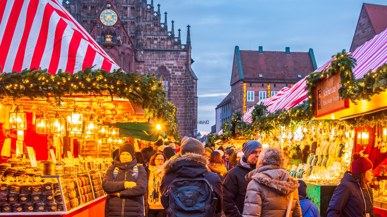 People strolling in the large Hauptplatz, in downtown Nuremberg, full of market stalls