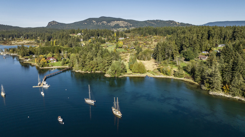 Sailboats sit moored off the shore of Orcas Island, Washington State, USA