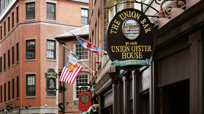 A brick building along the historic Freedom Trail in Boston, Massachusetts, featuring signs for The Union Bar (ye olde Union Oyster House) and Green Dragon Tavern.