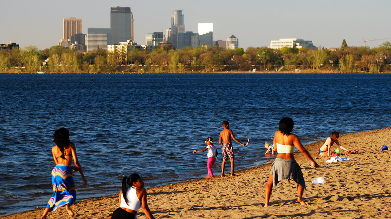 People at a lakeside beach in the heart of Minneapolis, Minnesota