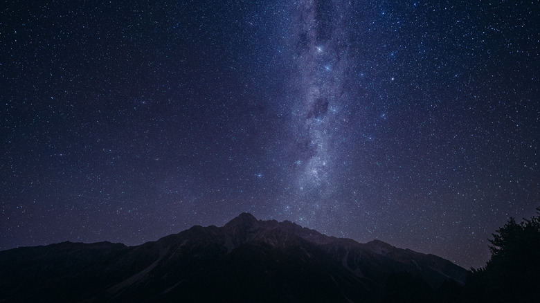 A starry night sky over a mountain range