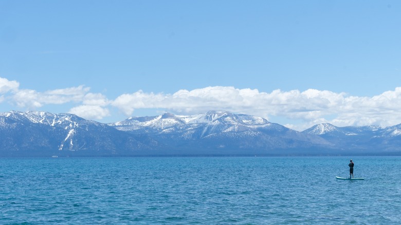 Sugar Pine Point Beach on Lake Tahoe with a paddle boarder on the peaceful lake.