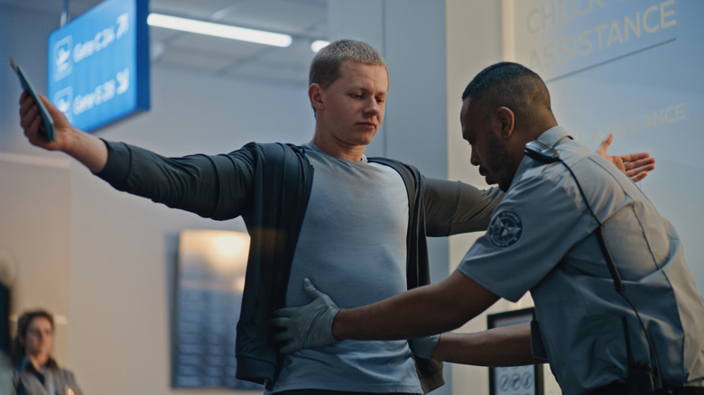 Someone getting a pat-down at a TSA checkpoint