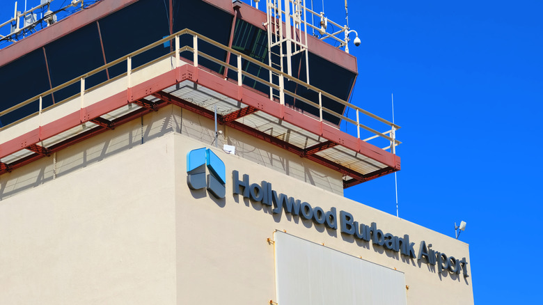 An air control tower with "Hollywood Burbank Airport" written on the front