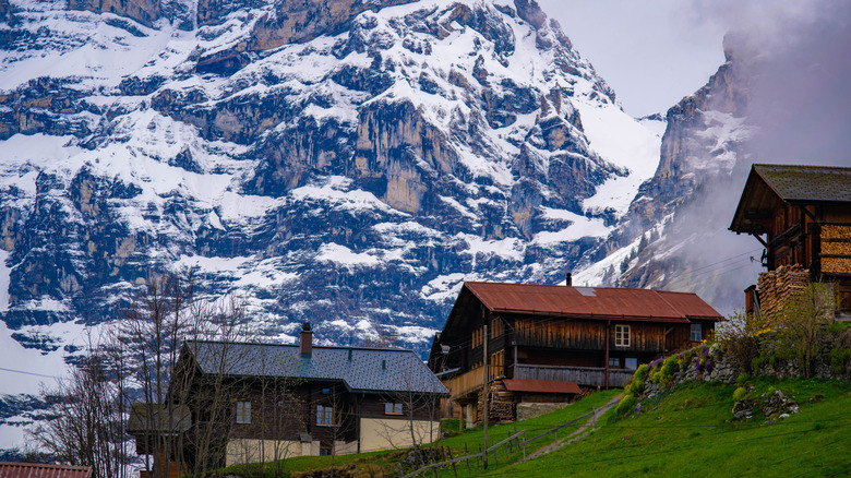 Wengen village in Switzerland, with cottages and a snowy mountain in the background