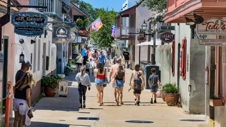 Pedestrians walking down St. George Street in St. Augustine, Florida's Historic District
