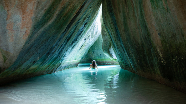 A woman in a bikini standing in the cave at the The Baths in Virgin Gorda