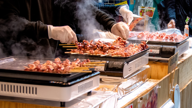 Octopus meat being cooked on skewers at Tsukiji Outer Market, Tokyo