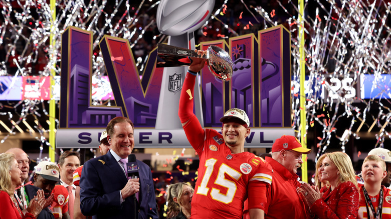 Kanas City Chiefs' quarterback Patrick Mahomes raises the trophy a the end of Super Bowl LVIII in Las Vegas