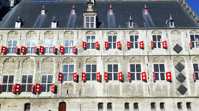 A large stone church with red shutters