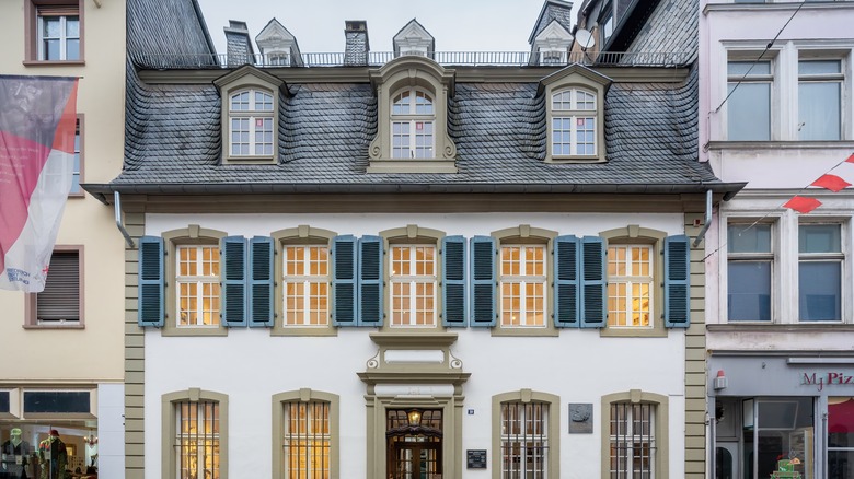 Historic white facade with blue shutters of Karl Marx House Museum in Trier, Germany
