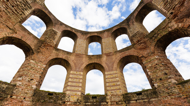 Arched windows in stone walls reaching towards the sky, Roman Imperial Baths, Trier, Germany
