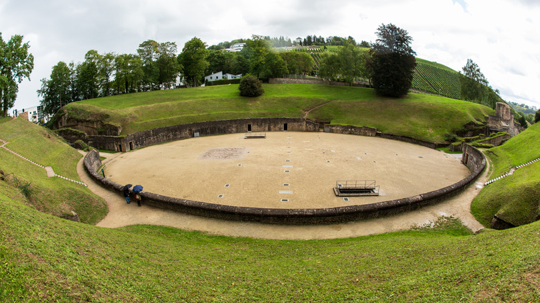 Panoramic view of the Trier Roman Amphitheater, now surrounded by grassy hills, Germany