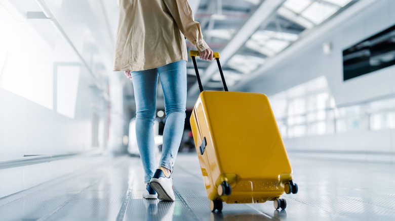 Person with a suitcase at an airport